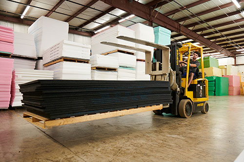 Gym wall padding fabrictor being moved with a forklift